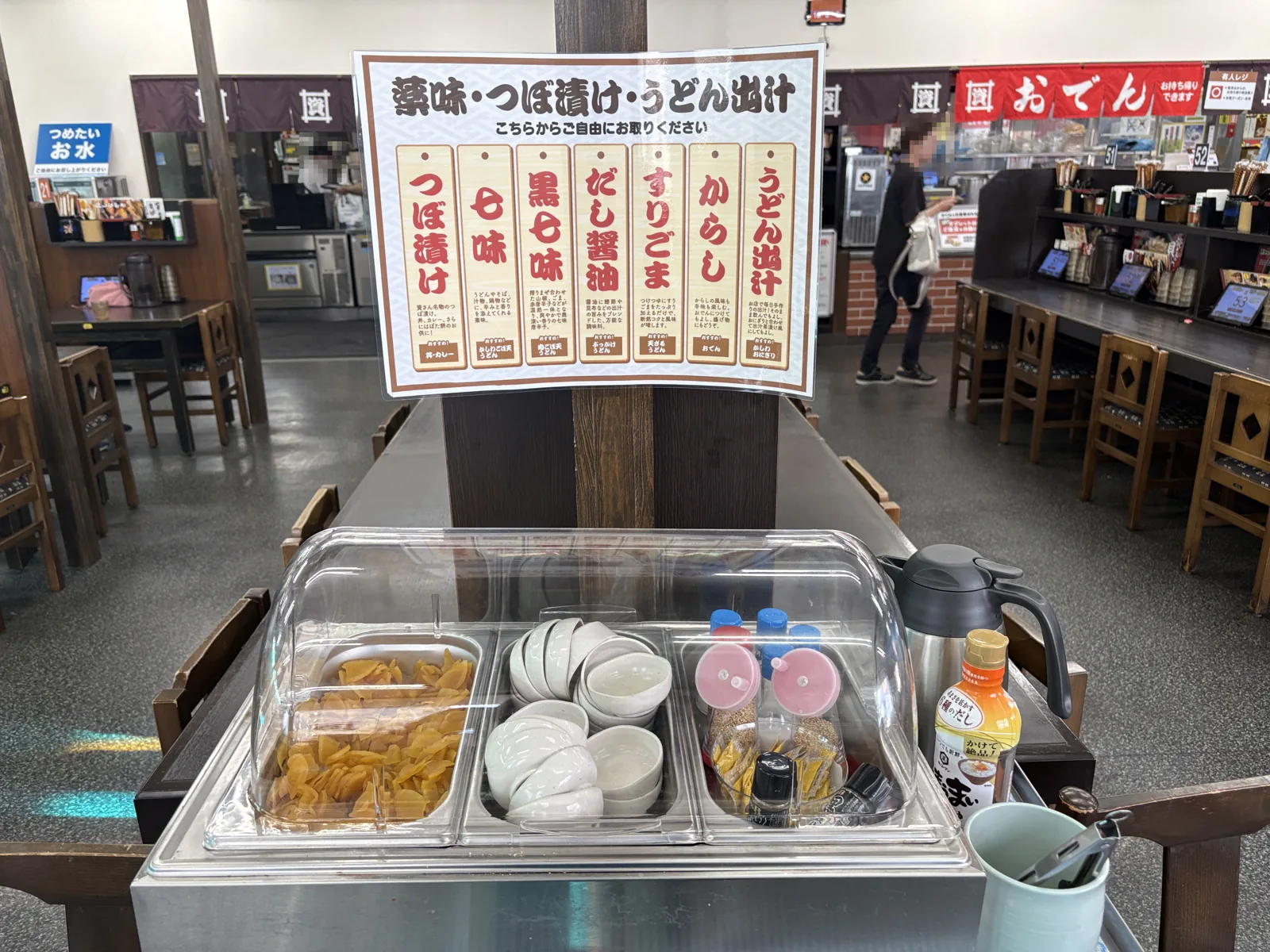 陣山店の店内中央に置かれた薬味コーナー。つぼ漬けや小皿、調味料がワゴンに並ぶ