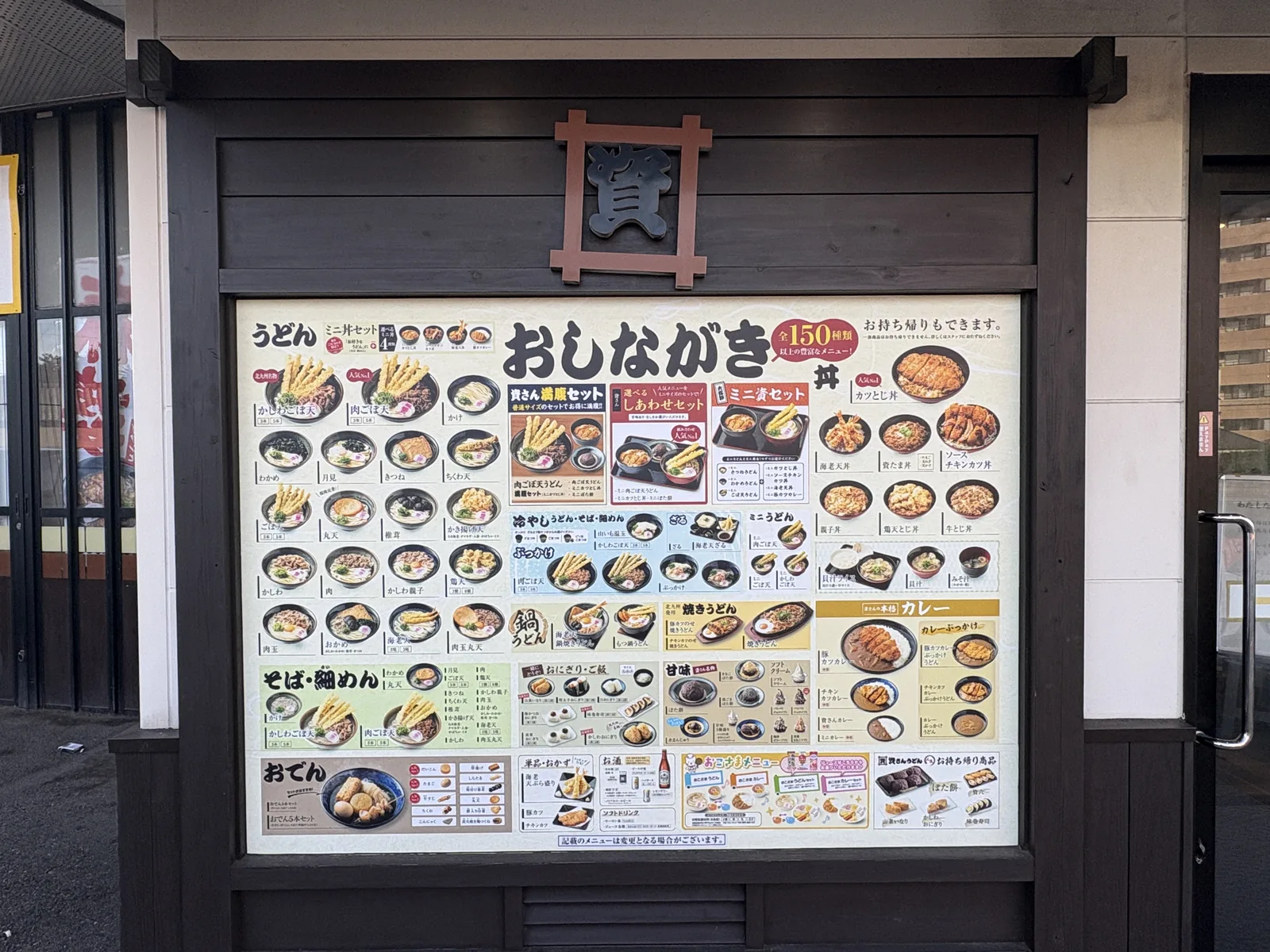 陣山店の店頭。「資」の看板の下に「おしながき 全150種類以上の豊富なメニュー！」の大きなメニュー看板