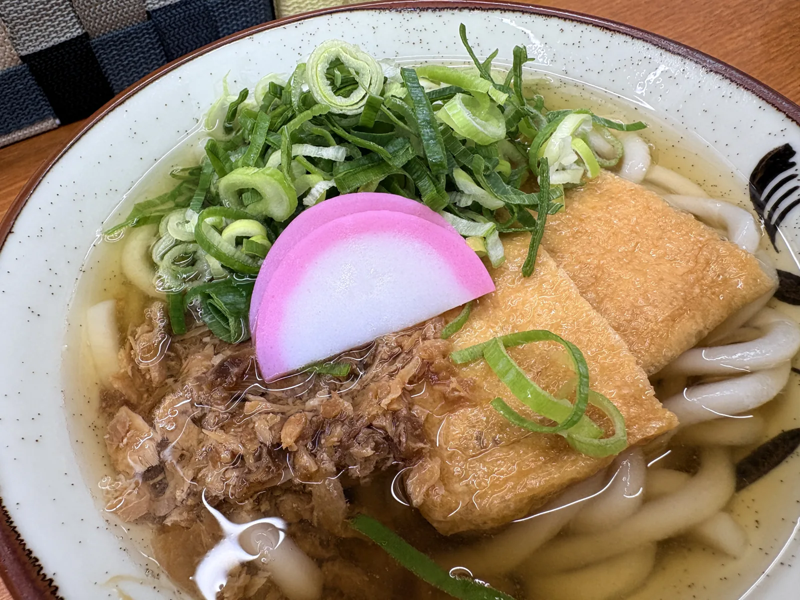 きつねうどん。大きなお揚げが2枚と、かしわ、たっぷりのねぎ