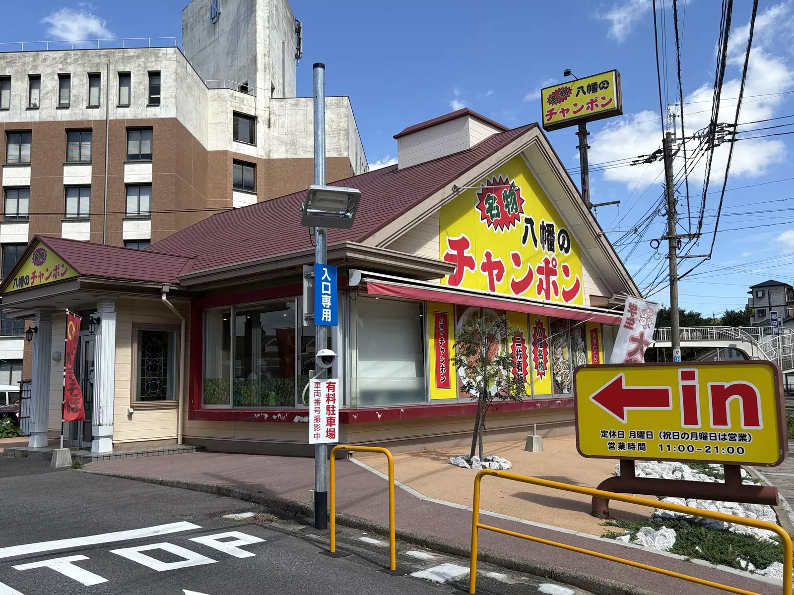 八幡のチャンポン平野店の外観。赤い屋根に黄色の大看板「名物 八幡のチャンポン」、右手に営業時間を書いた「in」の看板